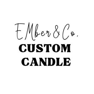 May include: White background with the text "Ember & Co. CUSTOM CANDLE" in black. The words "Ember & Co." are in a cursive font, while "CUSTOM CANDLE" is in a bold, sans-serif font. The image is a logo for a candle business.