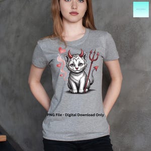 May include: A gray t-shirt featuring a cartoon devil cat with red horns, a trident, and heart-shaped smoke. The text "PNG File - Digital Download Only" is printed at the bottom of the shirt.