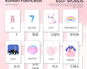 May include: Korean flashcards with English and Korean words. The cards feature illustrations of a cat, rainbow, dress, and city. The text on the cards includes "A", "Seven", "Cat", "Rainbow", "City", "AM/PM", "Kiss", and "Dress".