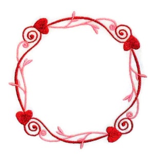 May include: Embroidered circular design featuring a red and pink heart-shaped wreath. The wreath has four red hearts, with swirling accents and delicate pink vines. The design is set against a white background.