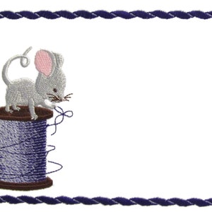 May include: A grey mouse with pink ears sits on a spool of blue thread. The mouse is holding a piece of thread in its mouth. The image is surrounded by a blue rope border.