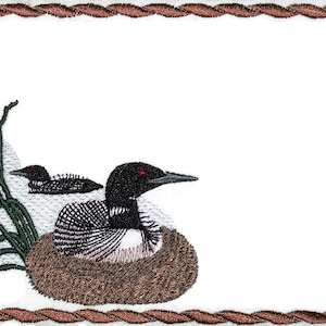 May include: Embroidered design of a loon and a loon chick in a nest with cattails in the background. The design is surrounded by a brown rope border.