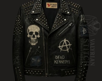 May include: Black leather jacket with silver studs and a skull graphic. Features a zipper closure, multiple patches, and the text "Dead Kennedys". The jacket has a classic biker style with a punk rock aesthetic.