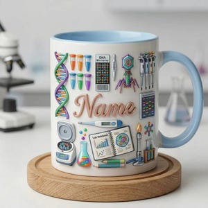 May include: White ceramic mug with a light blue handle and rim, decorated with science-themed illustrations. Features a DNA strand, test tubes, and the word "Name" in a decorative font. The mug sits on a wooden coaster.