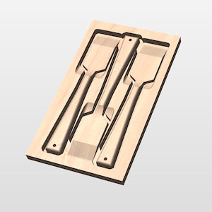 May include: A wooden tool organizer with three chisels. The chisels are arranged in a rectangular wooden tray. The chisels have a flat, rectangular blade and a long handle. The wood has a light brown color.