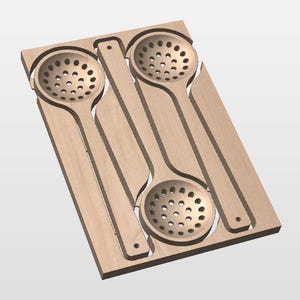 May include: A light-colored wooden board featuring two recessed, circular, perforated ladles or skimmers. The board has a rectangular shape with cutouts that mirror the shape of the two long-handled kitchen utensils nested within the wood.