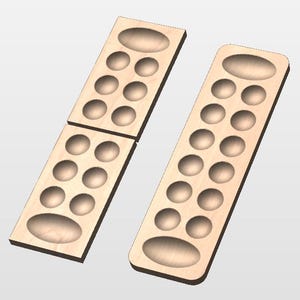May include: Three light-colored wooden Mancala game boards. Each board has a large oval indentation at each end and twelve smaller circular indentations in between. The boards are arranged in a way that they can be connected.