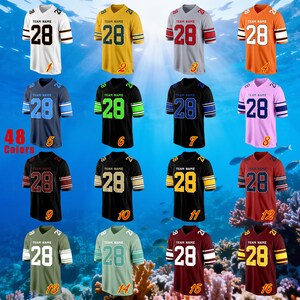 May include: Sixteen football jerseys in a variety of colours, including white, yellow, grey, orange, navy, black, pink, and maroon. Each jersey displays the number "28" and the text "TEAM NAME". The image also displays the text "48 Colors".