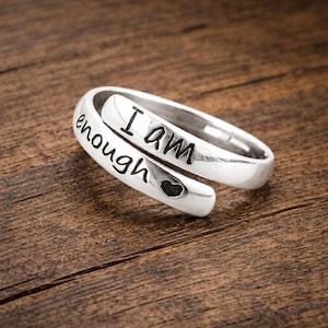 May include: A rustic wooden sign with the text "Welcome to our home" in white lettering. The sign features a distressed finish and a simple, inviting design, perfect for a front porch or entryway.