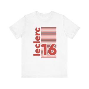May include: White t-shirt with a red graphic. The graphic features the word "leclerc" in a vertical font, with the number "16" below it. The number is inside a red rectangle with horizontal lines.