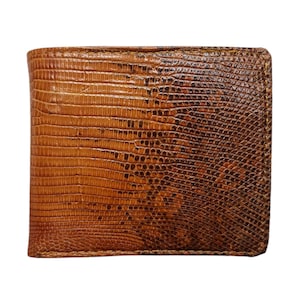 May include: A brown leather wallet with a reptile skin texture. The wallet is rectangular and has a bi-fold design. The color is a mix of light and dark brown, with a glossy finish.