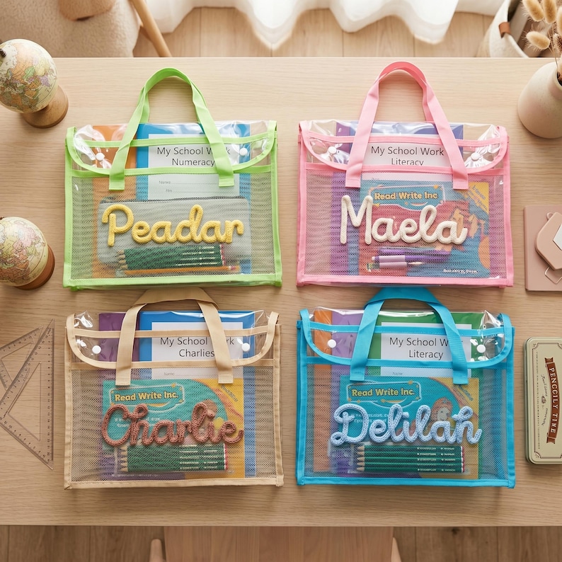 May include: Four rectangular mesh document bags with handles and snap closures, featuring personalized names in yarn lettering. The bags are lime green, pink, beige, and blue, each containing school workbooks and pencils labeled Read Write Inc.