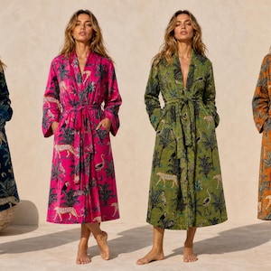 May include: Four long-sleeved robes with tie-waist belts, each featuring a repeating jungle-themed print of leopards, birds, and palm trees. The robes are displayed in navy blue, bright pink, olive green, and mustard yellow colourways.