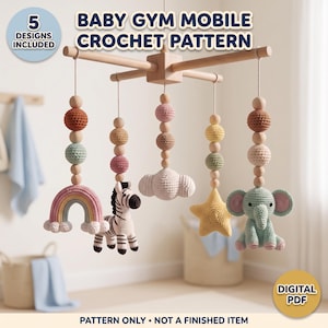 May include: A baby gym mobile crochet pattern featuring five hanging designs including a rainbow, a zebra, a cloud, a star, and an elephant. The mobile has a wooden cross frame with natural wooden beads and colorful crocheted elements. Text reads BABY GYM MOBILE CROCHET PATTERN and PATTERN ONLY - NOT A FINISHED ITEM.