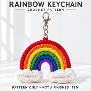 May include: A crochet rainbow keychain pattern featuring a red, orange, yellow, green, blue, and purple arch with white clouds at each end. The text RAINBOW KEYCHAIN CROCHET PATTERN and PATTERN ONLY NOT A FINISHED ITEM is visible on the image.