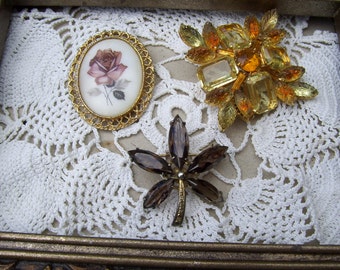 VINTAGE BROOCHES -- clear, amber, smokey, glass, gold tone flower, white