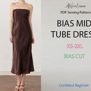 Puede incluir: Un vestido tubo midi marrón con escote palabra de honor y corte al bies. El texto dice: AtelierLiana, PDF Sewing Pattern, BIAS MIDI TUBE DRESS, XS-2XL, BIAS CUT, Confident Beginner. El vestido tiene un acabado satinado y cae por debajo de la rodilla.