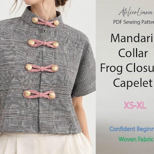 May include: A grey and black plaid capelet with a mandarin collar and four pink frog closures featuring gold buttons. The text reads: AtelierLiana PDF Sewing Pattern Mandarin Collar Frog Closure Capelet XS-XL Confident Beginner Woven Fabric.