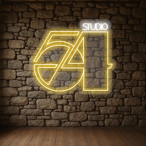 May include: A neon sign displaying "STUDIO 54" in a yellow outline, set against a stone wall. The sign is lit, with "STUDIO" in white. The background includes a wooden floor.