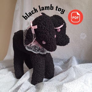May include: A black lamb toy with a fluffy texture, featuring a white lace collar and pink bows. The text "black lamb toy" is above the toy. A PDF icon is in the upper right corner.
