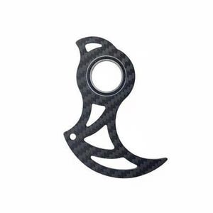 May include: A black carbon fiber bicycle disc brake rotor guard with a unique, stylized design. The guard features a central circular opening and a series of curved cutouts, creating an open, airy appearance. The guard is designed to protect the brake rotor.