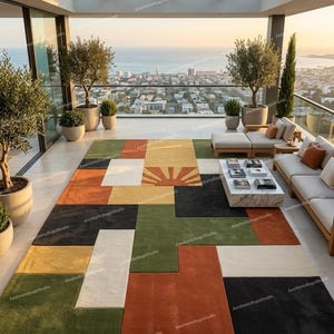 May include: A colorful geometric rug with a sunburst design, featuring blocks of green, orange, black, yellow, and white. The rug is placed on a patio with a view of the city and ocean. The text "AestheticRugsStudio" is visible on the rug.