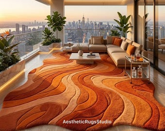 Könnte beinhalten: Ein großer, unregelmäßig geformter Teppich mit einem strukturierten, wellenförmigen Muster in Orange-, Terrakotta- und Cremetönen. Der Teppich liegt auf einem hellen Boden und zeigt den Text AestheticRugsStudio im unteren Mittelbereich.