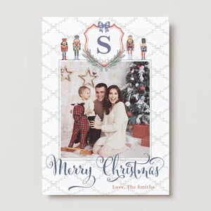 May include: Christmas card with a family photograph, a decorated Christmas tree, and the words "Merry Christmas" in cursive script. The card has a decorative border with nutcracker illustrations and the family's name.