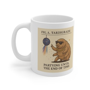 May include: A white ceramic mug featuring a graphic of a brown tardigrade wearing sunglasses and a gold chain, standing next to a disco ball. The text reads FIG. A. TARDIGRADE and PARTYING UNTIL THE END OF TIME in dark brown capital letters.