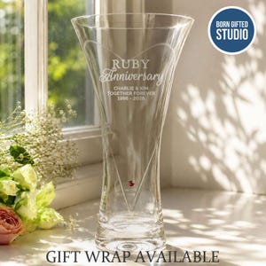 May include: A clear glass vase featuring an etched heart design and the text Ruby Anniversary, Charlie & Kim, Together Forever, 1986-2026. A small red crystal accent is embedded near the base of the heart. A circular logo reads Born Gifted Studio.