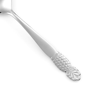 May include: A polished silver-tone metal spoon featuring a smooth, tapered handle that transitions into a textured, scale-like pattern near the base, ending in a decorative, fan-shaped finial with rounded edges and embossed detailing.