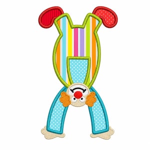 May include: A whimsical clown-themed applique design. The clown is depicted upside down with a colorful striped body, blue polka-dot legs, and red ear-shaped accents. The clown's face features orange cheeks, a red nose, and a smiling mouth.