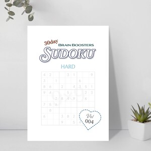 May include: A white Sudoku puzzle sheet with the text "30day BRAIN BOOSTERS SUDOKU HARD". The puzzle grid is visible, with numbers partially filled in. A heart-shaped graphic with "Vol 004" is in the lower right corner.