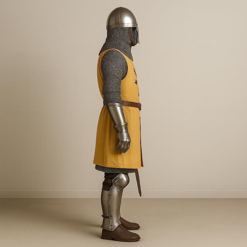 May include: A medieval knight's armor set, featuring a silver helmet, chainmail, and a mustard-yellow tunic with a brown belt. The armor includes silver gauntlets and greaves, with brown leather boots. The outfit is designed for historical reenactment or display.