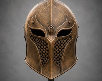 May include: Bronze-colored helmet with a pointed top and intricate detailing. The helmet features eye openings and a perforated lower face guard. It is displayed on a black stand against a gray backdrop, showcasing a medieval or fantasy theme.