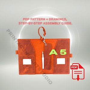 May include: An A5-sized, orange leather notebook with a pen, a strap, and a PDF download icon. The notebook has pockets and a pen holder. Text on the image reads "PDF Pattern + Drawings, Step-by-Step Assembly Guide."