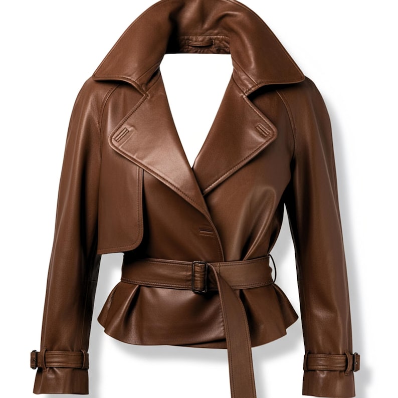 May include: A brown leather jacket with a wide collar, belted waist, and button closure. The jacket features a peplum hem and adjustable cuffs. This stylish outerwear is perfect for adding a touch of sophistication to any outfit.
