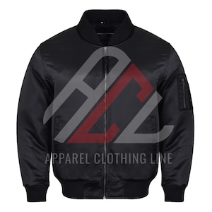 May include: Black bomber jacket with a ribbed collar, cuffs, and hem. The jacket has a zipper closure and a small pocket on the left sleeve. The text "APPAREL CLOTHING LINE" is printed on the front.