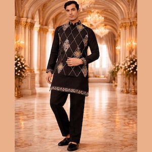 May include: A black ensemble featuring a long-sleeved shirt, vest, and pants. The vest has a diamond pattern with gold and floral embroidery. The shirt and pants are solid black. The outfit is worn with black shoes. The background is a grand hall with gold accents.