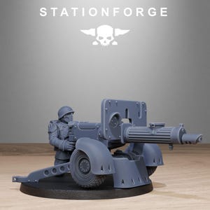 May include: A gray miniature artillery piece with a soldier figure. The artillery has a large barrel, wheels, and a shield. The soldier is wearing a helmet and uniform. The text "STATIONFORGE" is at the top.