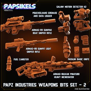 May include: A collection of miniature orange plastic weapon accessories labeled PAPZ INDUSTRIES WEAPONS BITS SET - 2. Includes the Armas-R11 Sumpak Beat Sniper Rifle, Armas-R9 Sumpit Light Sniper Rifle, Armas-Bulkan Pinatubo Heavy Incinerator, and accessories.