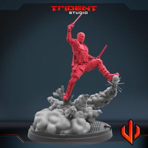 May include: A red action figure of a character in a dynamic pose, holding two swords. The figure is leaping from a cloud-like base with a missile. The Trident Studio logo is visible at the top.