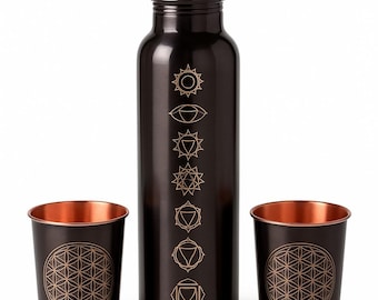 May include: A dark brown water bottle and two matching cups. The bottle has gold-coloured chakra symbols. The cups feature a gold-coloured Flower of Life design. The interior of the cups has a copper finish.