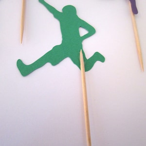Wooden picks are carefully attached to back of cutout using hot glue.