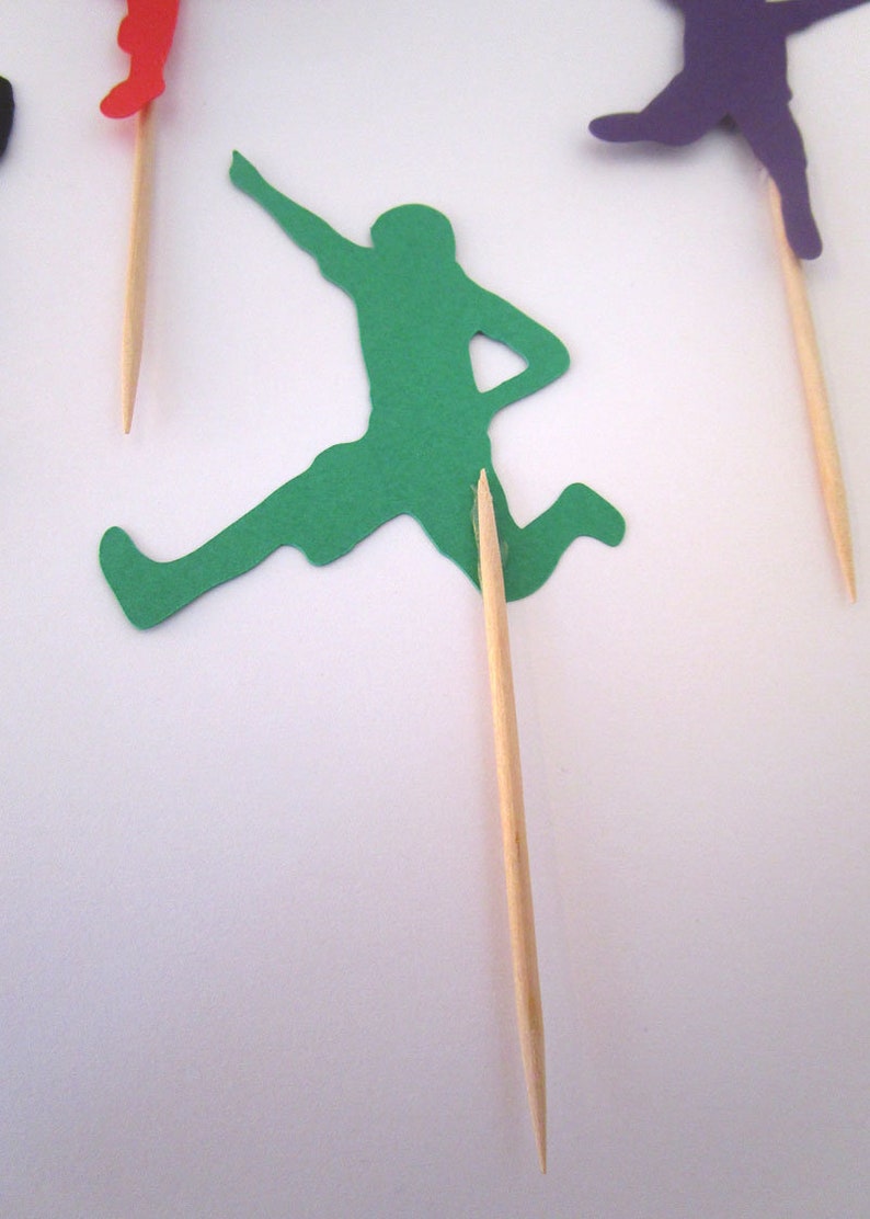 Wooden picks are carefully attached to back of cutout using hot glue.