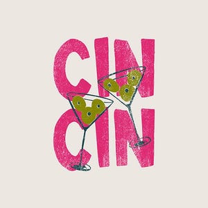 Puede incluir: Diseño gráfico con dos copas de martini llenas de aceitunas verdes frente al texto rosa brillante "CIN CIN". El texto tiene un efecto texturizado y el diseño está sobre un fondo crema. La imagen evoca un tema festivo.