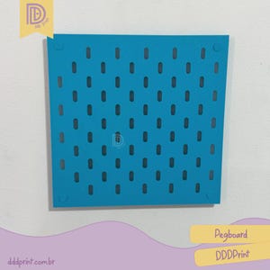May include: A teal pegboard with numerous oval holes. The pegboard is square with rounded corners. A logo is in the top left corner. The text "Pegboard" and "DDDPrint" are in a yellow rectangle in the bottom right corner.