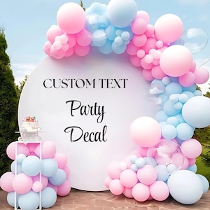 May include: A white circular party decal with the words "CUSTOM TEXT" and "Party Decal" in black script. The decal is decorated with pink and light blue balloons, and a small cake on a white stand.