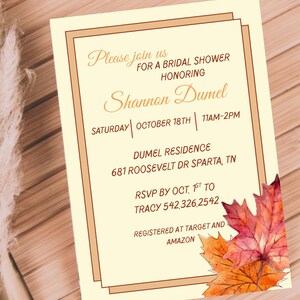 May include: A cream-colored invitation with a brown border and text. The invitation reads "Please join us for a bridal shower honoring Shannon Dumel" with the date, time, and location. Watercolor leaves in shades of orange and red are in the corner.