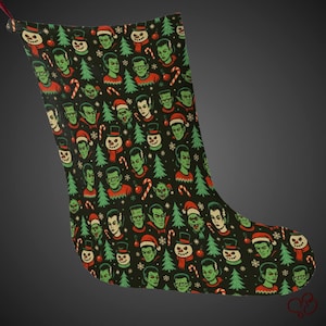 May include: A black Christmas stocking with a repeating pattern of green monster faces, Christmas trees, snowmen, and candy canes. The monsters are wearing Santa hats and sweaters. A festive holiday decoration.